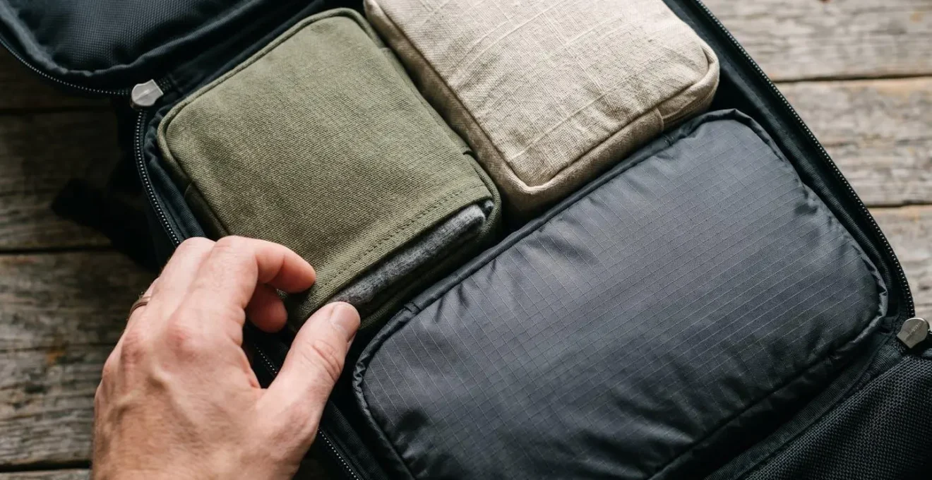 Modular packing cube system with versatile clothing pieces demonstrating a capsule wardrobe concept