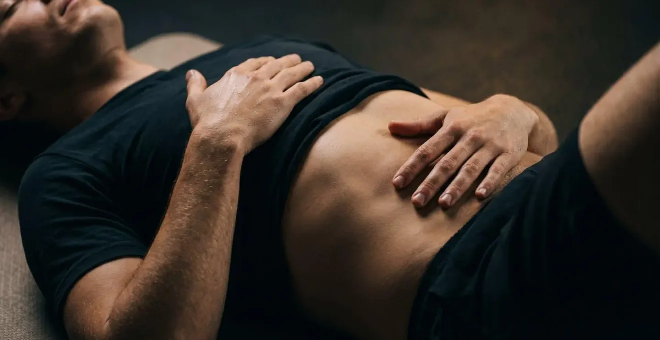 Person in recovery position performing diaphragmatic breathing after workout
